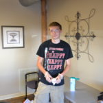 Alex pauses his janitorial work to take a picture