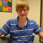 Isaac wearing a blue shirt