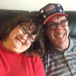 Patti and Ricky sitting together on the couch