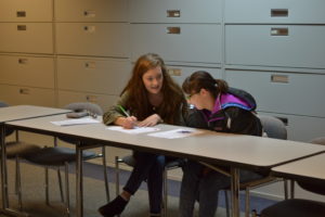 MU student sits with a participant from Inspiring Success