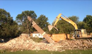 The chimney at 4632 being demolished as the old building is torn down.