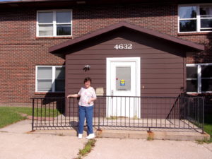 Picture of a woman standing in front of a building.