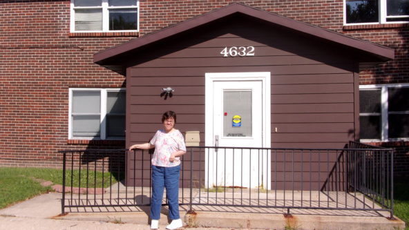Picture of a woman standing in front of a building.
