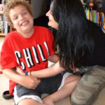 Boy sits on the floor with his mom