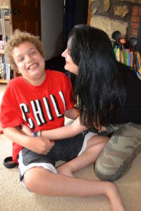 Boy sits on the floor with his mom