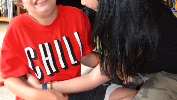 Boy sits on the floor with his mom