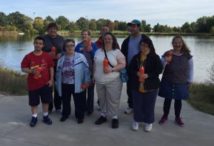 Group of participants posed for a picture in front of a lake