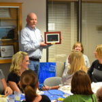 Michael holds up a digital picture frame.