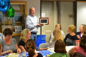 Michael holds up a digital picture frame.