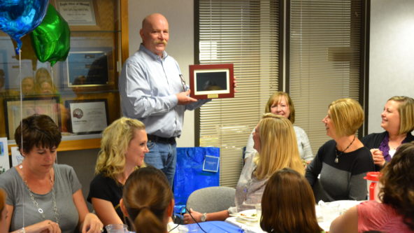 Michael holds up a digital picture frame.