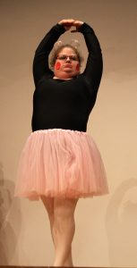 Woman in leotard and tutu on stage