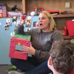 woman teaching class of small children