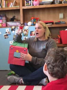 woman teaching class of small children, social skills group