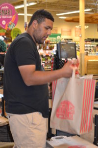 Isaac bags groceries at Lucky’s. 