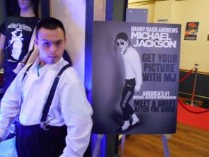 Man poses next to poster of Michael Jackson