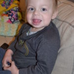 Xander sits on the couch.