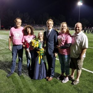 Group poses on the football field