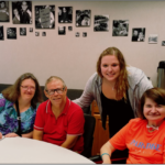Group of four people sitting at a table.
