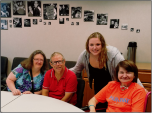 Group of four people sitting at a table.