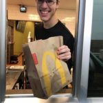 Josh handing food through the drive-thru window