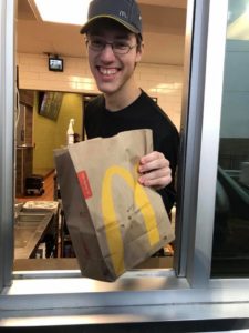 Josh handing food through the drive-thru window