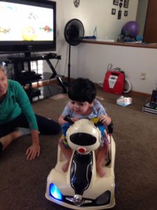 Mustafa rides on a battery powered car