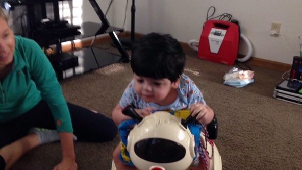 Mustafa rides on a battery powered car