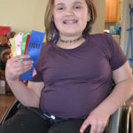 Sofia holds several ribbons while smiling