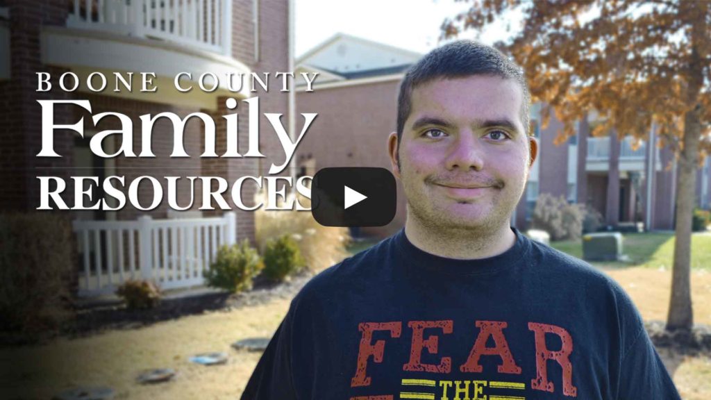 Photo of smiling young man wearing UMSL t-shirt. Click photo to play video.