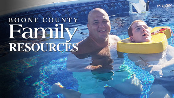 Young man with cerebral palsy enjoys floating in pool with family.