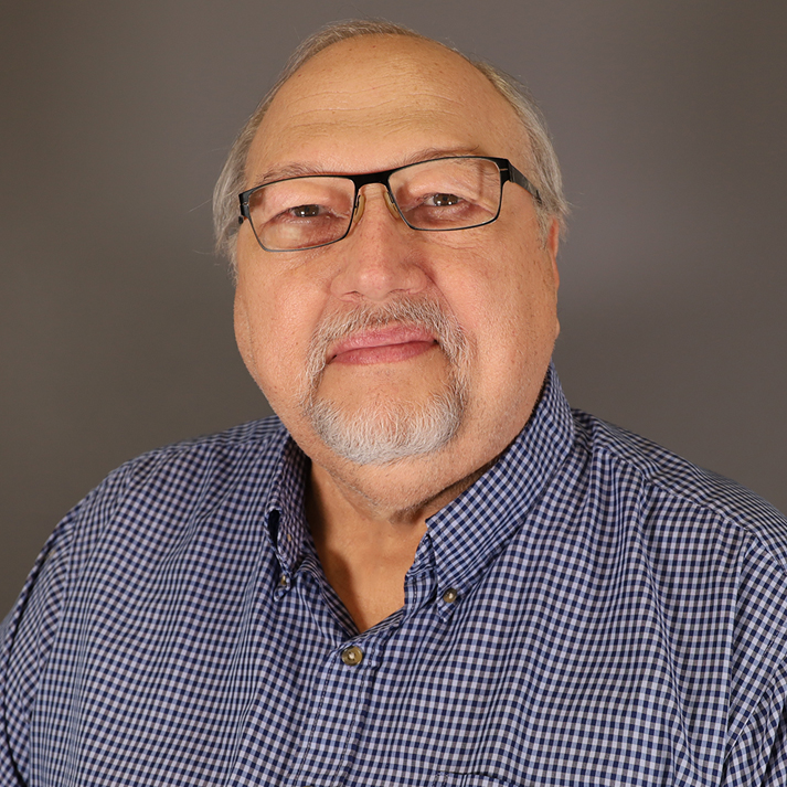 Don is a light skinned man with short grey hair, a grey goatee, and glasses.