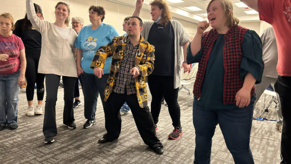 A group of people are dancing and singing along to music in the BCFR Les Wagner Community Room.