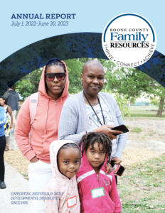 Annual report cover showing a family of four people standing in the grass smiling at the annual picnic.
