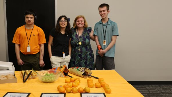 Work crew participants Hayden, Amanda and Adam (left to right) pose for a photo at graduation with Supervisor Coresa Coloney