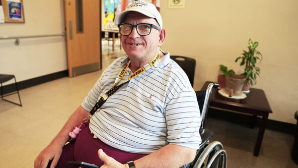 Robert poses for a photo in the lobby of Oak Towers.